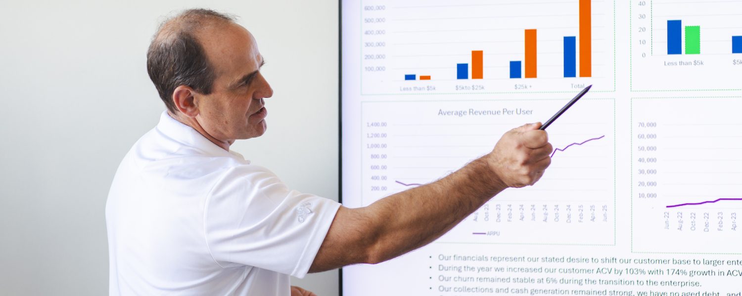 Craig demonstrating his fractional CRO skills in front of a screen: Hire a Fractional CFO
