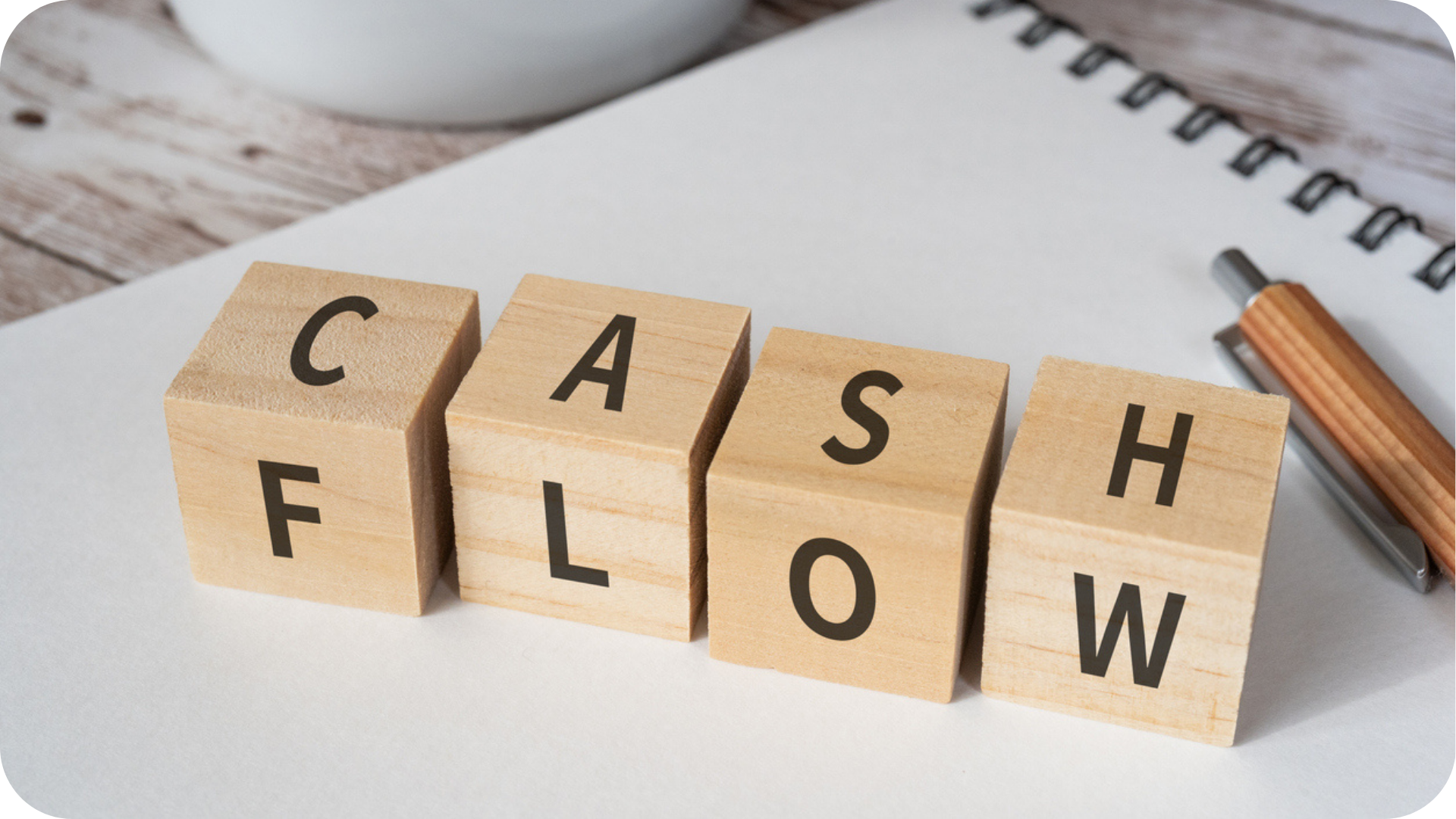 Cash Flow Forecast for Startup Business shown by wooden cubes showing the word "Cash flow"